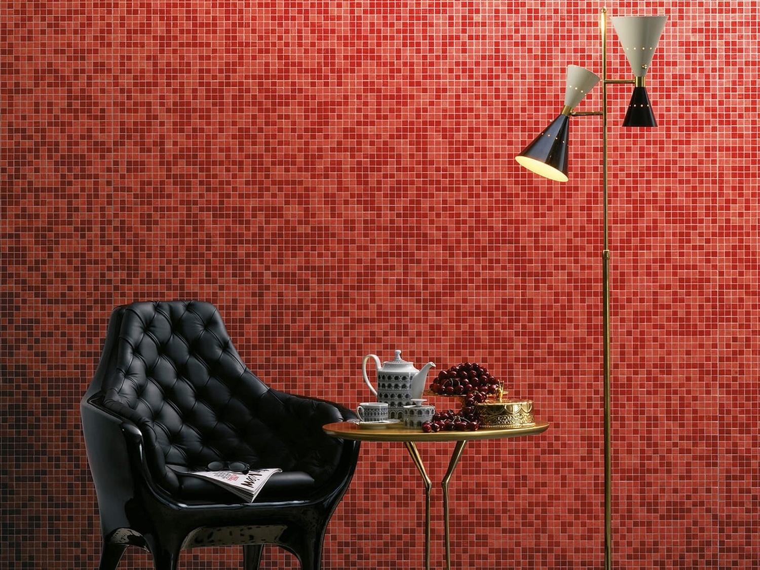 Czarny fotel przy czerwonej mozaice i lampie fot. Bisazza